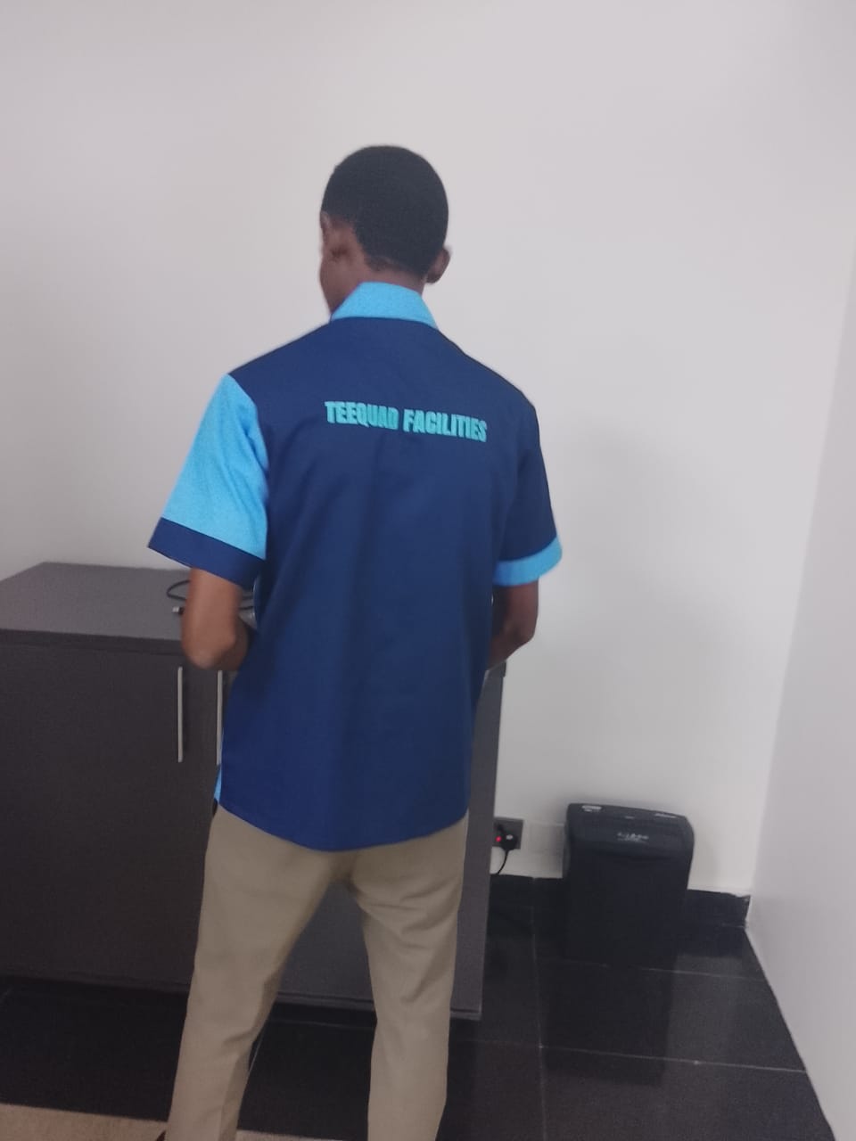 TEEQUAD facilities team member servicing an office